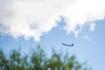 Airplane at fly on the sky with clouds