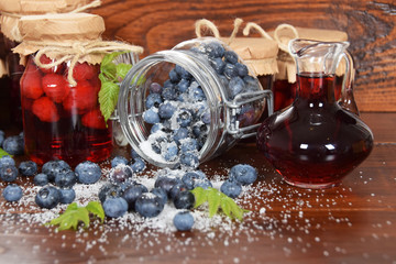 Spilled sugar berries on a wooden table with berry juice