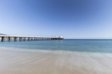 Fototapeta premium Malibu Pier with motion blur water near Los Angeles in Southern California. 