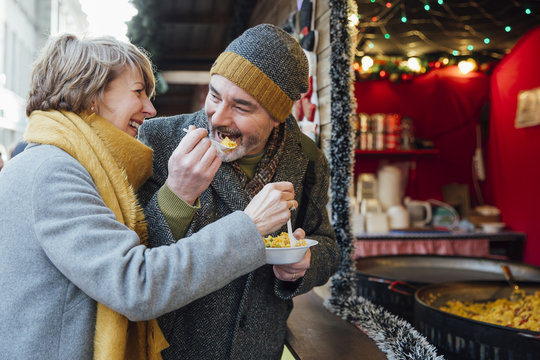 Elderly Couple Eating at Christmas Market