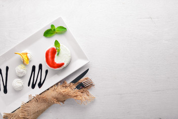 Panacotta dessert. On a wooden background. Top view. Free space for text.