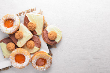 Pastry with chocolate. On a wooden background. Top view. Free space for your text.