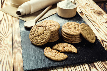 Biscuit sweet cookie background. Domestic stacked butter biscuit pattern concept,close up macro.Homemade cookies on wooden table.Cereal biscuits with the sesame,peanuts,sunflower and amaranth.