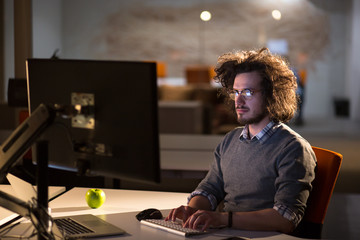 man working on computer in dark office