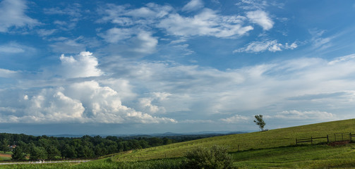 A summer storm gathers over the mountains and countryside whose bucolic beauty inspires calm and serenity to all.