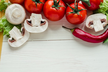 Ingredients for tasty salad making: greens ,champignons mushroom, tomatoes, herbs, cucumber, carrot