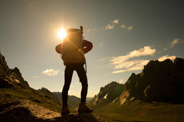 woman with backpack hiking in mountains travel lifestyle