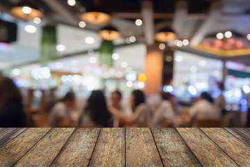 Wood table top with People in restaurant with bokeh light blurred customer abstract background