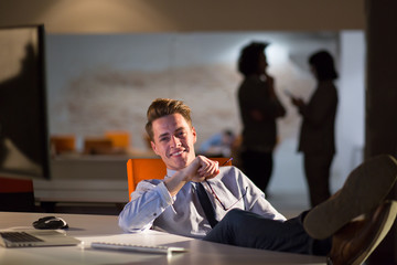 businessman sitting with legs on desk at office