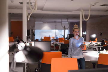 Fototapeta premium woman working on digital tablet in night office