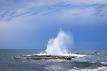 Waves crashing on rock