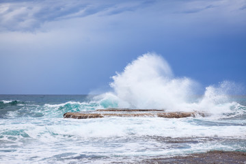 Waves crashing on rock