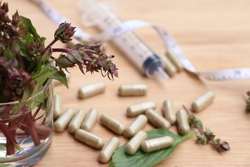 Fototapeta na wymiar herbal basil with capsule