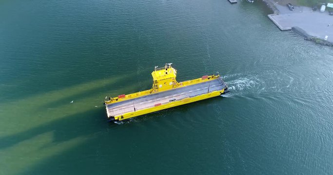 Empty cable ferry, Cinema 4k aerial view following a car ferry at baronsalmi, at a evening, in the finnish archipelago, Uusimaa, Finland
