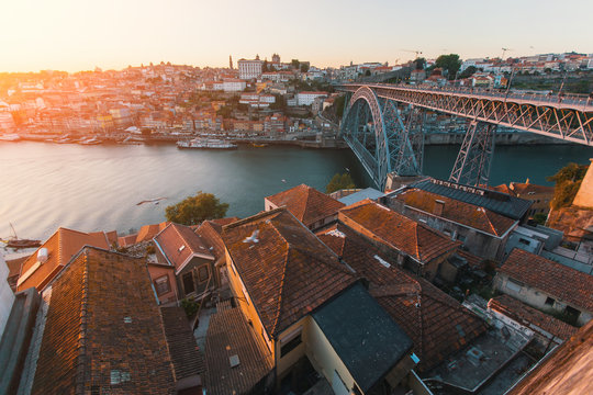 Bird's-eye view of Douro river and Dom Luis I bridge at sunset, Porto, Portugal.