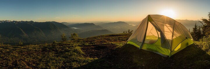 tent overlooking mountains at sunsrt backlit