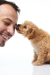 Puppy licking man face