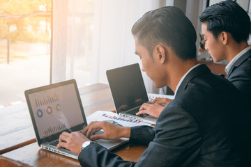Asian business man working and typing computer notebook