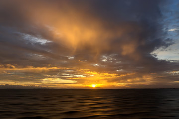 Fototapeta na wymiar Sunset sky with rain cloud on the lake.