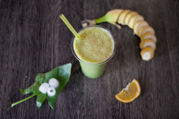 Summer fresh drink. Green nature smoothie. Favorite vegeterian food. Photo of green smoothies on a wooden board.