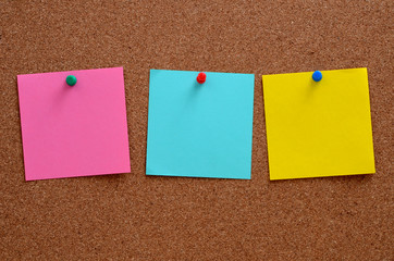 Blank notes pinned into brown corkboard