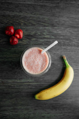 Summer fresh drink. Strawberry nature smoothie. Favorite vegeterian food. Photo of berry smoothies on a wooden board.