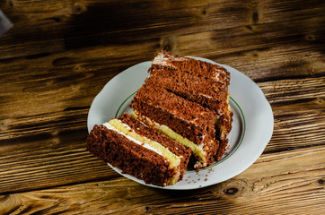 Biscuit cake in plastic container on wooden table