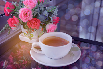 Abstract soft blurred and soft focus a cup of cappuccino, hot coffee with the flower, bokeh, beam light, lens flare effect tone background.