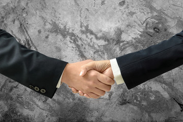 Asia Businessman and businesswoman handshake to make a deal and blank wall for text and background. Copy Space