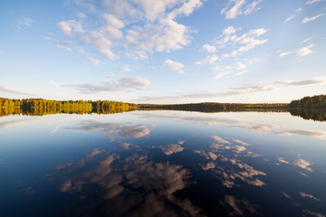 Still lake perfect reflection of sky and clouds