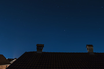 Chimney with bricks Like A Little House On The Roof at starry sky