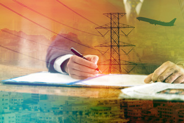 Double exposure of businessman signs a contract with cityscape , High voltage electricity and airplane - industry concept