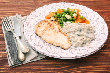 Turkey fillet with mushrooms in cream sauce and vegetables