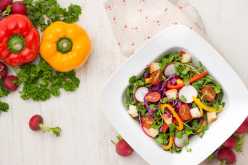 Homemade fresh green vegetable salad on table.