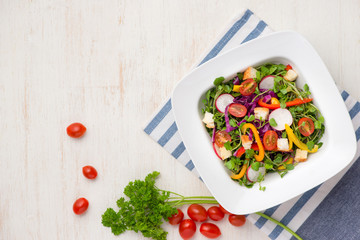 Homemade fresh green vegetable salad on table.