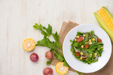 Homemade fresh green vegetable salad on table.