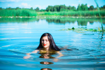 Beautiful young sexy brunette hair stylish woman on a lake and reeds posing on a camera and rest on weekend no human complex