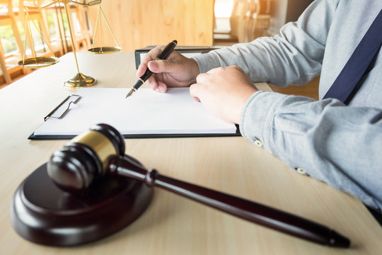 lawyer hand writes the document in court (justice, law)