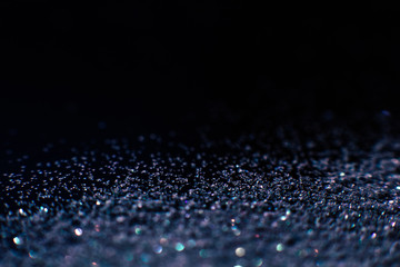 Abstract shining glitters violet makeup background. Blurred multicolored tinsel, selective focus with shallow depth of field. Glisten foil backdrop, christmas magic , eyeshadow closeup concept