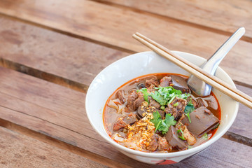 Rice noodles with spicy pork sauce (Nam ngiao) is a noodle soup or curry of the cuisine of the Tai Yai people. Nam ngiao has a characteristic spicy and tangy flavor. Thai food.