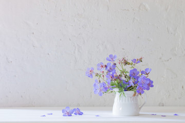 flowers in jug on white background