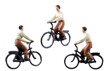 Miniature figure ride bicycle isolated on white background with clipping path