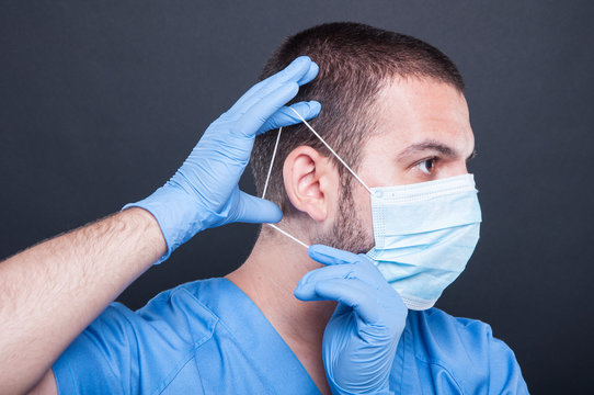 Side View Doctor Putting On His Sterile Mask