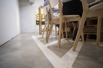 The feet of the women sitting on the chair