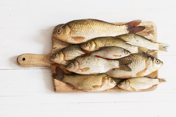 river raw fish on wooden table