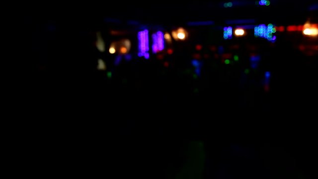 Girl dancing on stage on blurred background in the night club