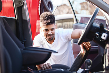 Man cleaning car interior