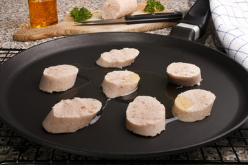raw irish white pudding with oil in a pan