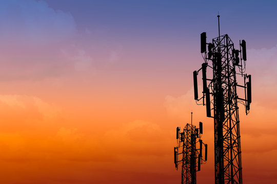 silhouette of communication tower with dusk sky with space for text