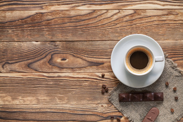Coffee cup and cookie on wood
